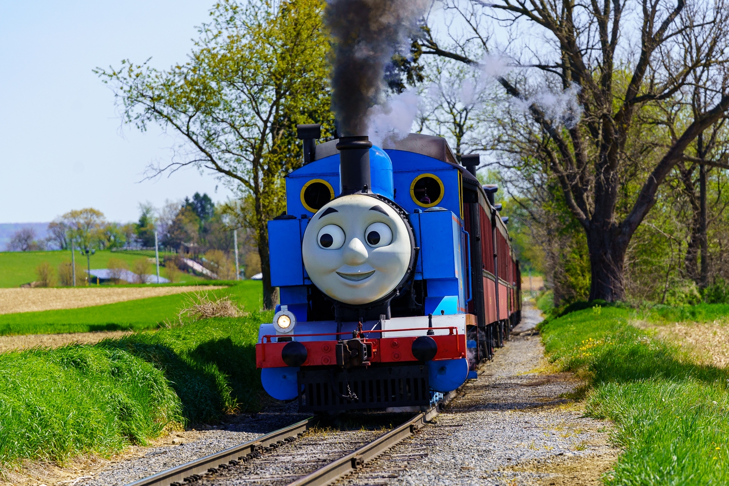 Ronks, PA, USA - April 30, 2022: Thomas the Tank Engine chugs along the Strasburg Rail Road tracks in rural Lancaster County, Pennsylvania.