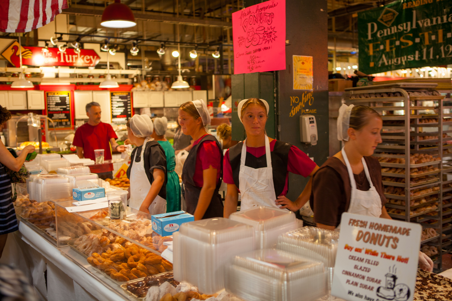 Amish selling doughnuts at market.